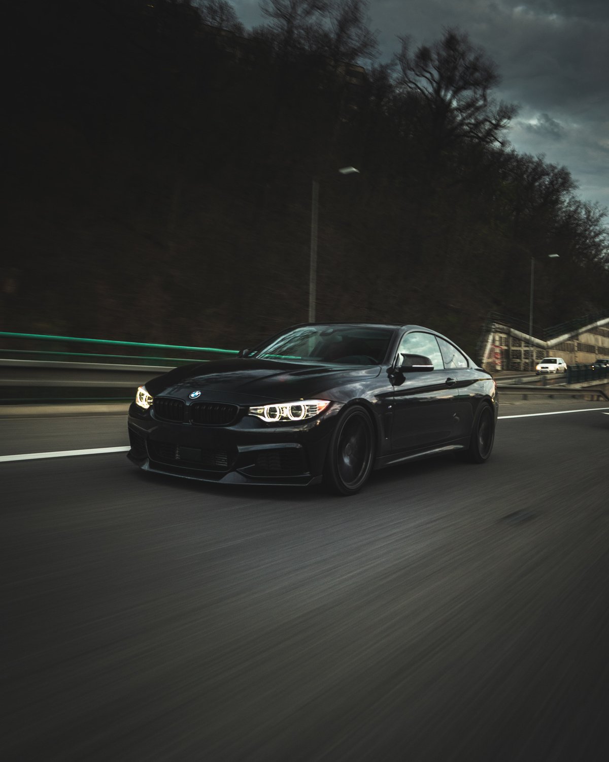 Black Luxury Car on an Asphalt Road