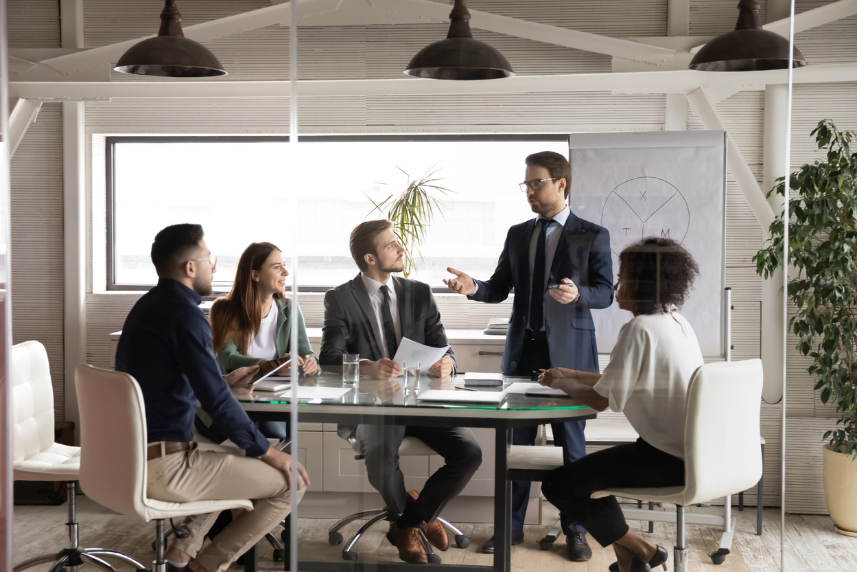 Young professional business trainer educating managers at workshop.